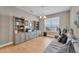 Well-lit home office featuring custom built-ins, a large window, and a comfortable seating area at 8272 Procida Isle Ln, Windermere, FL 34786