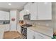 Kitchen featuring stainless steel appliances, granite countertops, and white cabinets at 8272 Procida Isle Ln, Windermere, FL 34786