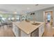 Kitchen featuring a large island with white cabinetry and stainless steel dishwasher at 8272 Procida Isle Ln, Windermere, FL 34786