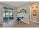 Bright living area featuring wood floors, sliding glass doors, and a music nook with keyboard and artwork at 8272 Procida Isle Ln, Windermere, FL 34786