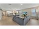 Open-concept living space with modern kitchen, dining area, and a comfortable grey sectional sofa at 8272 Procida Isle Ln, Windermere, FL 34786