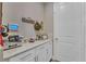 Convenient mud room with ample counter space, white cabinetry, and a door to an additional storage area at 8272 Procida Isle Ln, Windermere, FL 34786