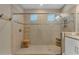 Spacious walk-in shower with frameless glass enclosure, neutral tile, and convenient built-in shelving at 8272 Procida Isle Ln, Windermere, FL 34786