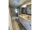 Bathroom featuring double sinks, vanity with storage, and tiled shower at 879 Little Bend Rd, Altamonte Springs, FL 32714