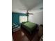 Bright bedroom with hardwood floors, ceiling fan, and storage shelves at 879 Little Bend Rd, Altamonte Springs, FL 32714