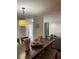 Inviting dining area featuring stylish lighting and a view into the living room at 879 Little Bend Rd, Altamonte Springs, FL 32714