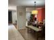 Dining room with adjacent living room, a dining room table with a bench, and a modern light fixture at 879 Little Bend Rd, Altamonte Springs, FL 32714