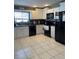 Well-lit kitchen featuring tile floors, white cabinets, modern appliances and granite countertops at 879 Little Bend Rd, Altamonte Springs, FL 32714