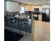 Well-lit kitchen features white cabinets, black appliances, tile backsplash, and bar seating at 879 Little Bend Rd, Altamonte Springs, FL 32714