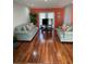 Spacious living room with hardwood floors and comfortable sofas for relaxing and entertaining at 879 Little Bend Rd, Altamonte Springs, FL 32714