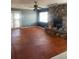 Bright living room features stone fireplace, ceiling fan, and sliding doors for natural light and easy access at 879 Little Bend Rd, Altamonte Springs, FL 32714