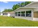 Backyard featuring the exterior of home with large picture window, grass, and landscaping at 8814 Sw 93Rd Ln # B, Ocala, FL 34481