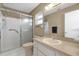 Bathroom featuring a glass-enclosed shower, neutral tiles, and a vanity with good lighting at 8814 Sw 93Rd Ln # B, Ocala, FL 34481