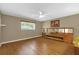 Spacious bedroom featuring wood floors, ceiling fan, and natural light from a window at 8814 Sw 93Rd Ln # B, Ocala, FL 34481