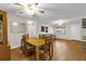 Open concept living and dining room featuring laminated floors, wood furniture, and natural light at 8814 Sw 93Rd Ln # B, Ocala, FL 34481