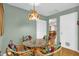 Bright dining area features unique wicker chairs and charming Tiffany-style pendant light fixture at 8814 Sw 93Rd Ln # B, Ocala, FL 34481