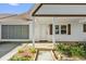 Charming front porch with traditional columns, white brick, and an attached two-car garage at 8814 Sw 93Rd Ln # B, Ocala, FL 34481