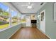 Inviting sunroom with plenty of windows, light green walls, and wood-look floors, ideal for enjoying the outdoors from inside at 8814 Sw 93Rd Ln # B, Ocala, FL 34481