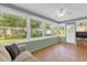 Bright sunroom featuring large windows, light green walls, and wood-look floors, perfect for relaxing at 8814 Sw 93Rd Ln # B, Ocala, FL 34481