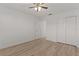 A simple bedroom featuring light wood floors, a ceiling fan, and a closet at 909 Cajon Ct, The Villages, FL 32159