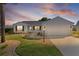 Charming single-story home with a well-manicured lawn and a two-car garage at 909 Cajon Ct, The Villages, FL 32159
