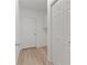 Hallway with updated floors and white doors, providing storage and access to other rooms at 909 Cajon Ct, The Villages, FL 32159