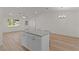 Open-concept layout with a kitchen island, dining area, and a living space at 909 Cajon Ct, The Villages, FL 32159