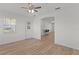 An open-concept living room featuring light wood floors with a view into an eat-in kitchen at 909 Cajon Ct, The Villages, FL 32159