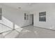 Bright sun room featuring tile flooring, paneled walls, windows, and a ceiling fan at 909 Cajon Ct, The Villages, FL 32159