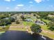 Overhead view of houses in a neighborhood featuring a lake with boats and personal docks at 1111 Myrtle Breezes Ct, Fruitland Park, FL 34731
