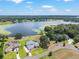 Scenic aerial view of a lakeside property with lush trees and a serene waterfront setting at 1111 Myrtle Breezes Ct, Fruitland Park, FL 34731