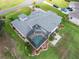 Aerial view of a large home with a screened pool area and beautiful landscaping, highlighting its spacious layout at 1111 Myrtle Breezes Ct, Fruitland Park, FL 34731