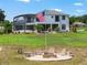 Expansive backyard with a fire pit and an American flag, perfect for outdoor gatherings and recreation at 1111 Myrtle Breezes Ct, Fruitland Park, FL 34731