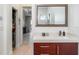 Bathroom with warm wood vanity and sleek white countertop, enhanced by natural light at 1111 Myrtle Breezes Ct, Fruitland Park, FL 34731