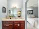 Stylish bathroom vanity with dark wood cabinets and modern fixtures adjacent to a bedroom at 1111 Myrtle Breezes Ct, Fruitland Park, FL 34731
