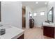 Clean bathroom featuring a tiled shower, double vanities, and natural lighting at 1111 Myrtle Breezes Ct, Fruitland Park, FL 34731