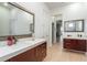 This luxurious bathroom has double vanities, sleek hardware, and great lighting at 1111 Myrtle Breezes Ct, Fruitland Park, FL 34731
