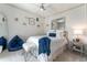 Bright bedroom with a ceiling fan, comfortable furniture, tasteful decorations, and a large mirror at 1111 Myrtle Breezes Ct, Fruitland Park, FL 34731