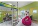 Brightly colored bedroom with loft bed, playful decor, and access to a sunny balcony at 1111 Myrtle Breezes Ct, Fruitland Park, FL 34731