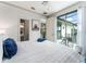 Cozy bedroom features neutral walls, a ceiling fan, and glass doors that open to an outdoor patio at 1111 Myrtle Breezes Ct, Fruitland Park, FL 34731