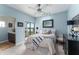 Bright bedroom with blue walls and balcony access with peaceful water views at 1111 Myrtle Breezes Ct, Fruitland Park, FL 34731