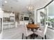 Cozy breakfast nook adjacent to the kitchen, with a round wooden table and lots of natural light at 1111 Myrtle Breezes Ct, Fruitland Park, FL 34731