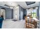 Charming dining room with chandelier, decorative door and view through a large window at 1111 Myrtle Breezes Ct, Fruitland Park, FL 34731