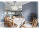 Bright dining room with modern chandelier, view to piano room, lake view and wine rack at 1111 Myrtle Breezes Ct, Fruitland Park, FL 34731