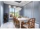 Bright dining room with modern chandelier, view to exterior and wine rack at 1111 Myrtle Breezes Ct, Fruitland Park, FL 34731