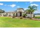 Beautiful home features a manicured lawn, well-maintained landscaping, and a modern architectural style near the lake at 1111 Myrtle Breezes Ct, Fruitland Park, FL 34731