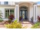 Beautiful entry with brick walkway, well-maintained landscaping, and stylish front door at 1111 Myrtle Breezes Ct, Fruitland Park, FL 34731