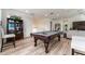 Attractive recreation area includes a billiard table, comfortable seating, and a decorative display cabinet at 1111 Myrtle Breezes Ct, Fruitland Park, FL 34731
