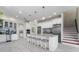 Bright kitchen featuring a large center island with seating, modern appliances, and tile backsplash at 1111 Myrtle Breezes Ct, Fruitland Park, FL 34731