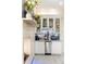 Close-up of a dry bar with white cabinets, stainless steel appliances, and a light tile backsplash at 1111 Myrtle Breezes Ct, Fruitland Park, FL 34731